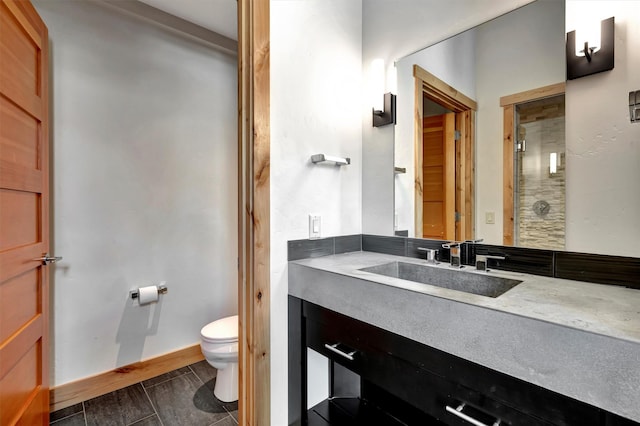 1180 Reardon Ln, Alberton, MT 59820 - bathroom featuring toilet, baseboards, and vanity