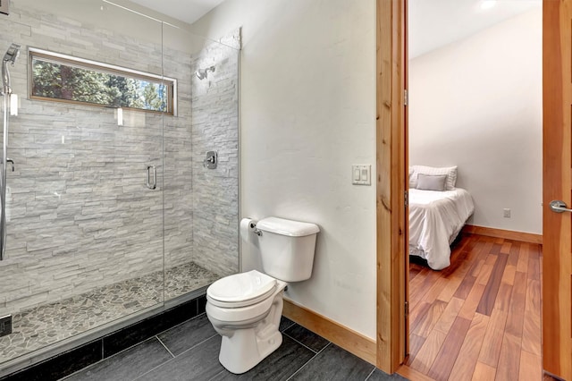 bathroom with walk in shower, toilet, and hardwood / wood-style flooring