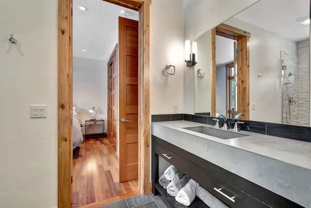 bathroom featuring vanity, hardwood / wood-style floors, and walk in shower