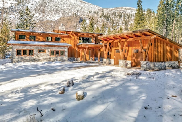 snow covered house with a mountain view