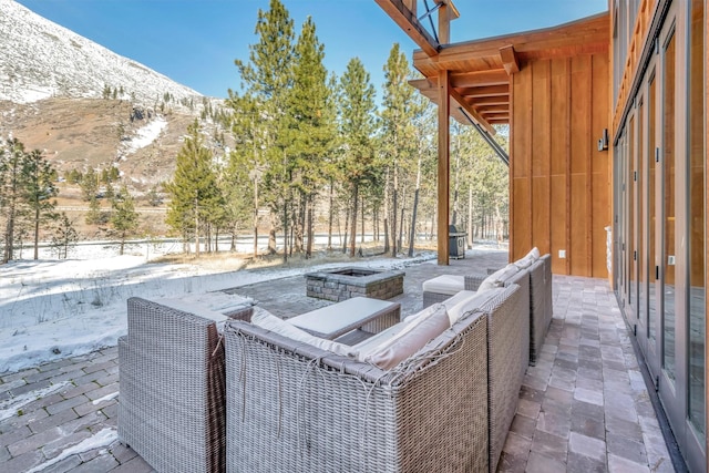 1180 Reardon Ln, Alberton, MT 59820 - view of front of home with board and batten siding, stone siding, and a mountain view