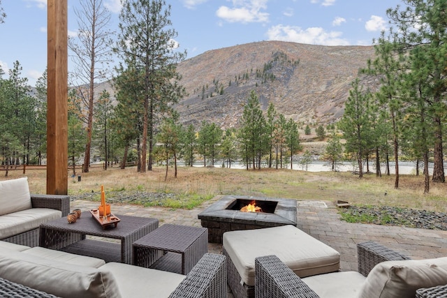 1180 Reardon Ln, Alberton, MT 59820 - view of patio featuring an outdoor living space with a fire pit and a water and mountain view