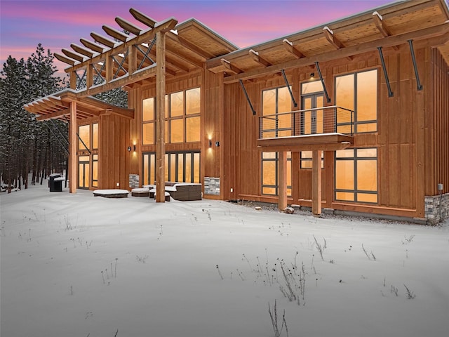 1180 Reardon Ln, Alberton, MT 59820 - back of property at dusk featuring a balcony