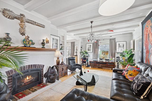 living room with an inviting chandelier, a fireplace, hardwood / wood-style floors, and beam ceiling