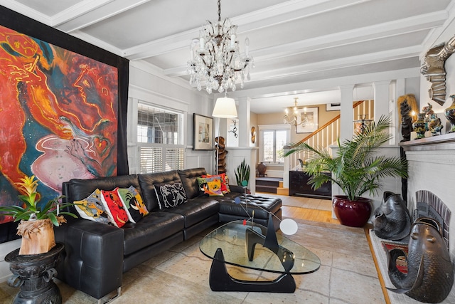 living room featuring beamed ceiling, decorative columns, a fireplace, and a chandelier