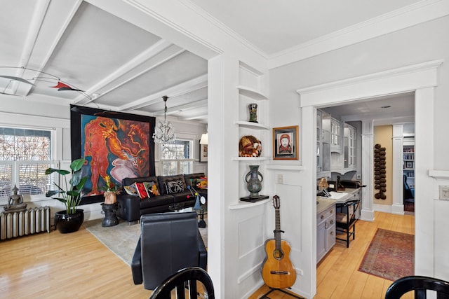 interior space featuring crown molding, radiator heating unit, and light hardwood / wood-style flooring