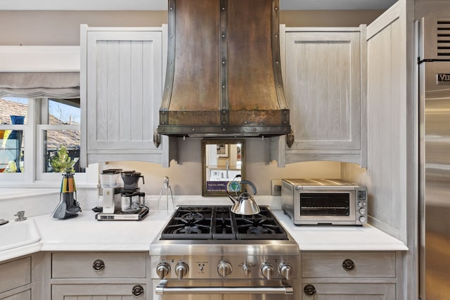 kitchen with premium appliances and premium range hood