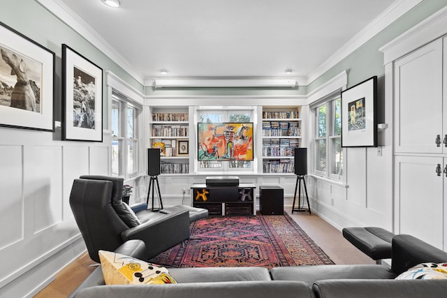 office space featuring a fireplace, crown molding, plenty of natural light, and built in shelves