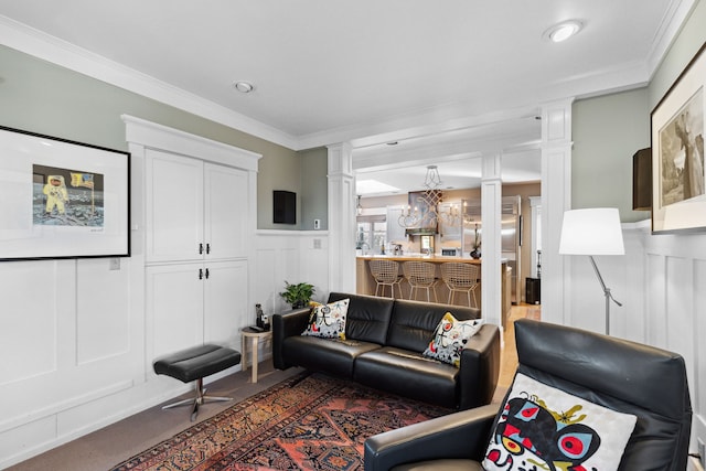 living room with decorative columns and crown molding