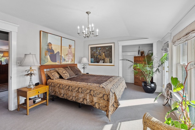 carpeted bedroom featuring an inviting chandelier