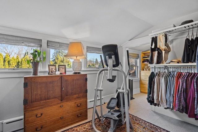 exercise area with lofted ceiling, light carpet, and baseboard heating