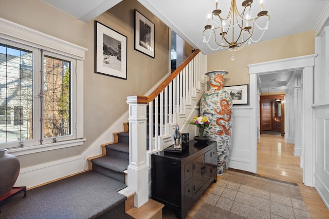 stairway with a notable chandelier