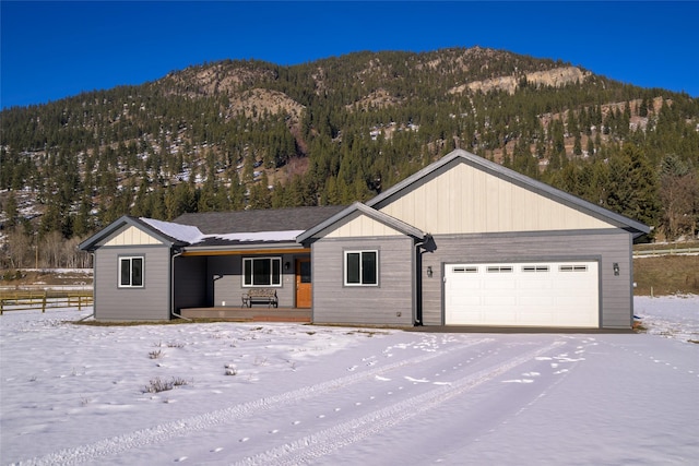 ranch-style home with a garage and a mountain view