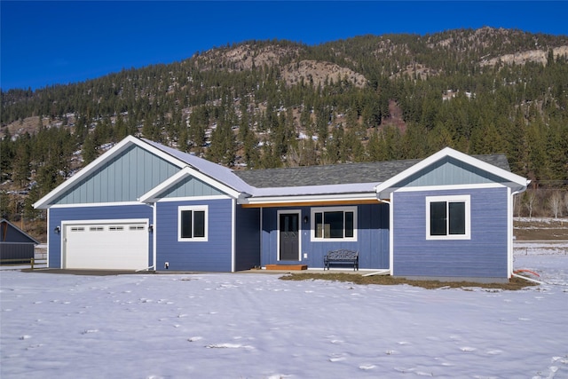 view of front of property featuring a garage and a mountain view