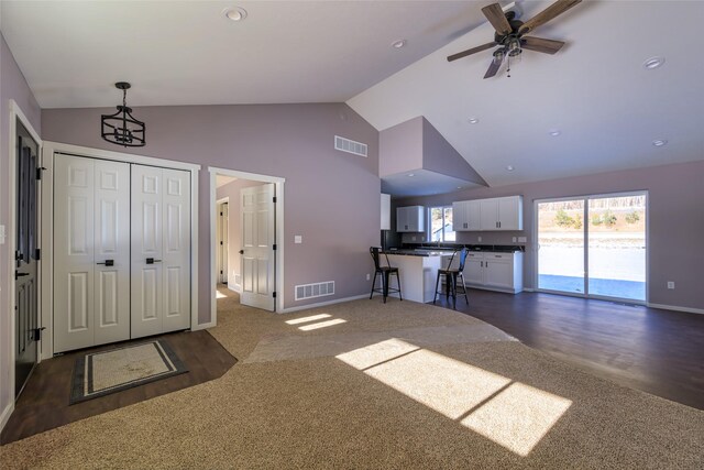 interior space with high vaulted ceiling and ceiling fan