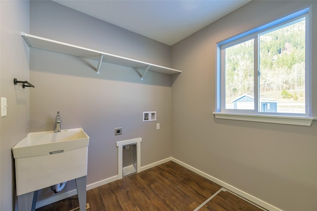 laundry room with electric dryer hookup, sink, hookup for a washing machine, and dark wood-type flooring