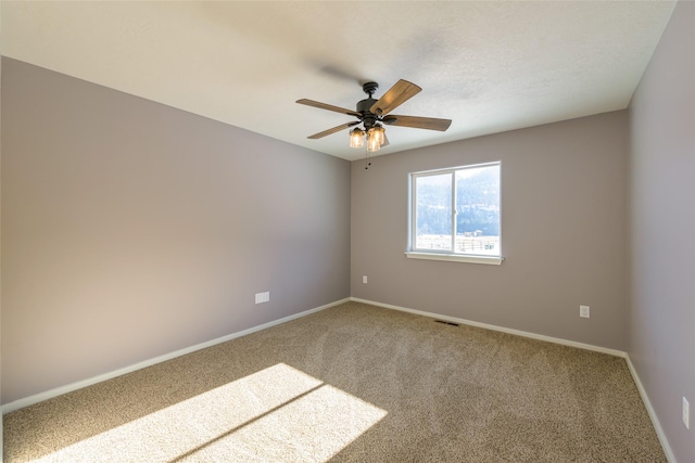 unfurnished room featuring ceiling fan and carpet floors