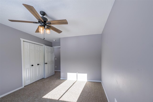 unfurnished bedroom with carpet floors, a closet, and ceiling fan