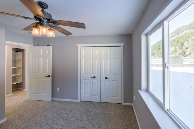 unfurnished bedroom featuring ceiling fan, a closet, carpet flooring, and access to exterior