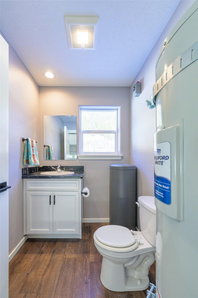 bathroom with vanity, hardwood / wood-style floors, and toilet