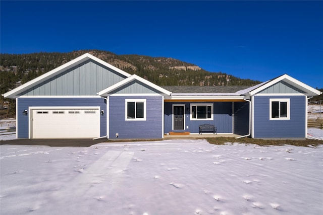 view of front facade with a mountain view and a garage