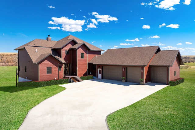 view of front of property featuring a garage and a front yard