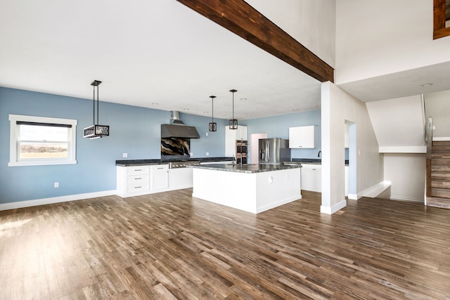 kitchen with pendant lighting, a center island, stainless steel fridge with ice dispenser, and white cabinets