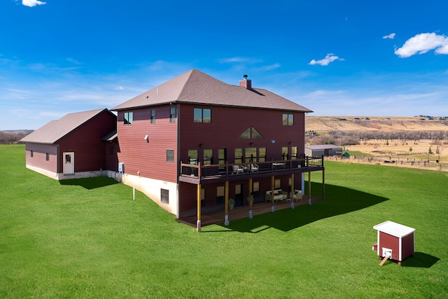 back of house featuring a yard and a deck