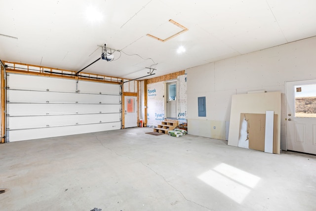 garage featuring a garage door opener and electric panel