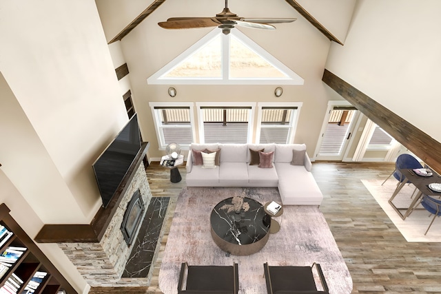 living room with hardwood / wood-style flooring, ceiling fan, and a high ceiling