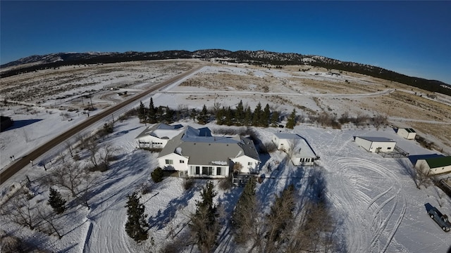 snowy aerial view with a mountain view