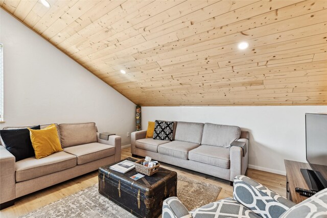 dining room with vaulted ceiling with beams, wood ceiling, and light hardwood / wood-style floors