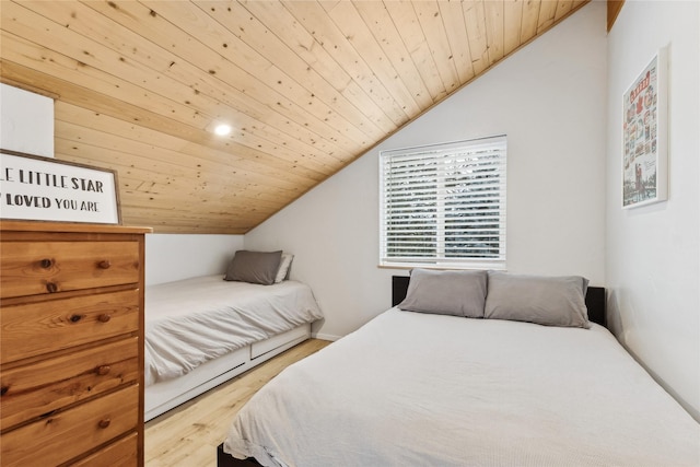 bedroom featuring vaulted ceiling, wood ceiling, and light hardwood / wood-style floors