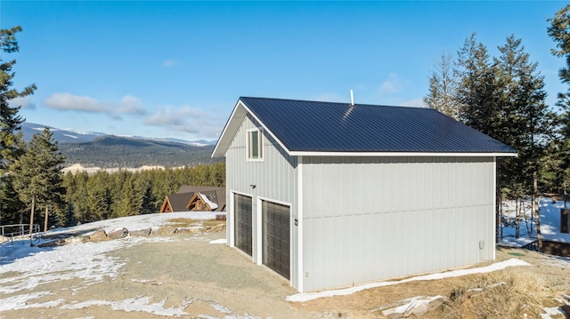 view of home's exterior with a garage and a mountain view