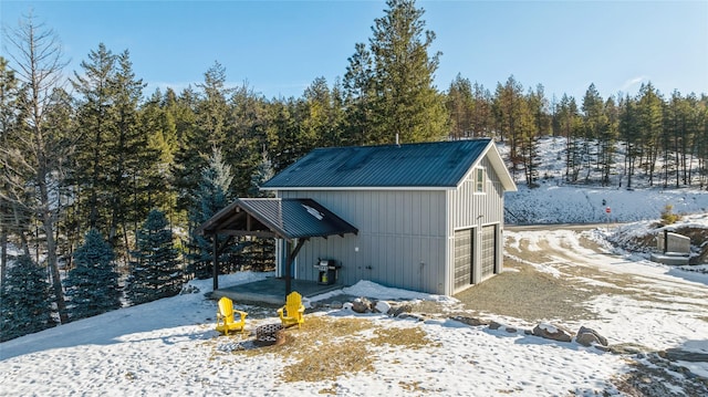 snow covered structure featuring an outdoor structure