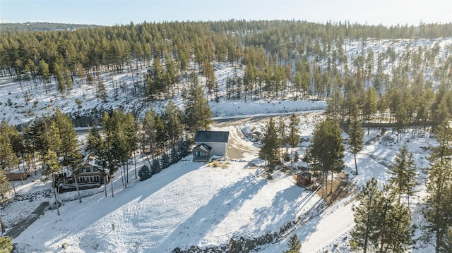 snowy aerial view with a forest view