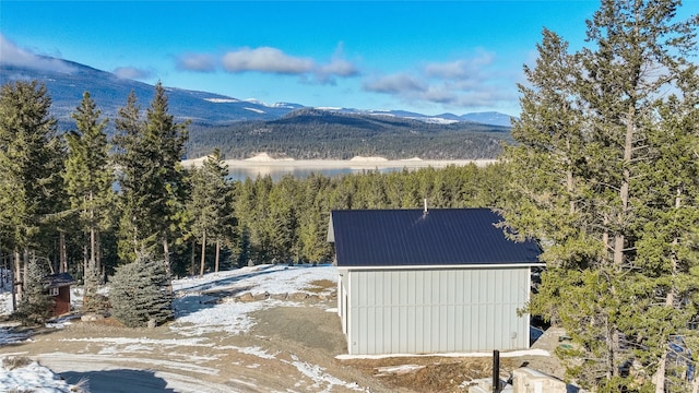 property view of mountains featuring a forest view