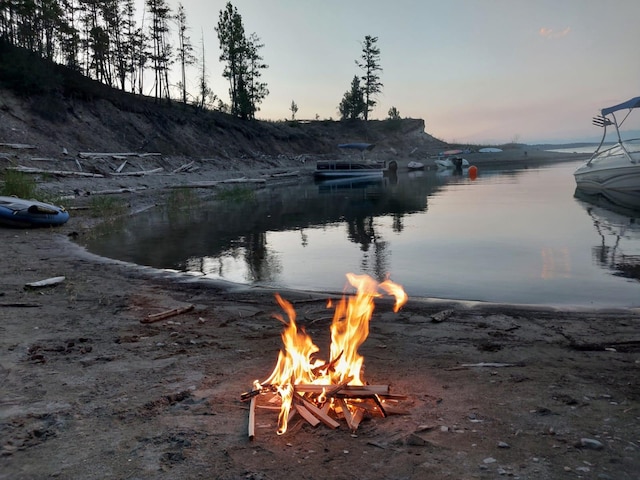 property view of water with an outdoor fire pit