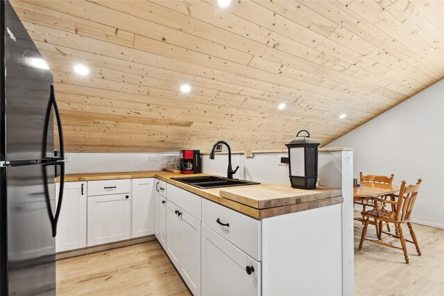 living room featuring wood ceiling, vaulted ceiling, and light wood-type flooring