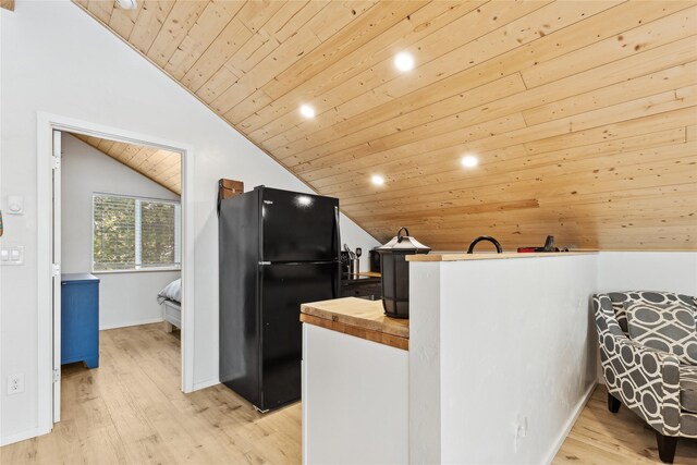 living room with vaulted ceiling, wood ceiling, and light hardwood / wood-style floors