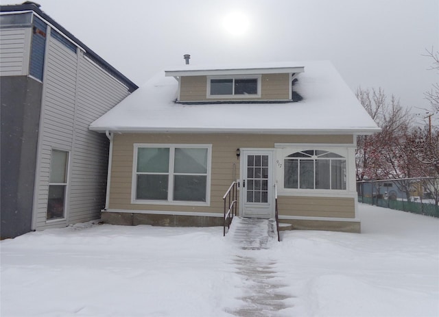 view of snow covered back of property