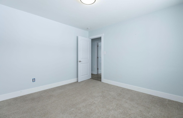 spare room featuring light colored carpet