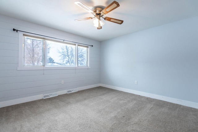 spare room featuring carpet floors and ceiling fan