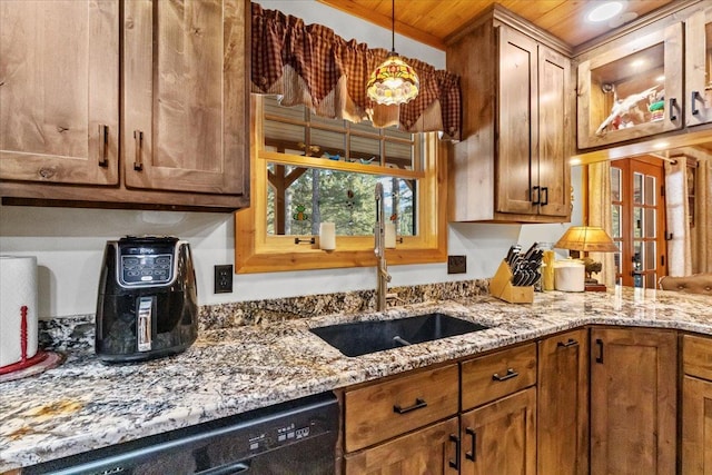 192 Crystal Lakes Dr, Eureka, MT 59917 - kitchen with a sink, black dishwasher, wooden ceiling, light stone countertops, and brown cabinetry
