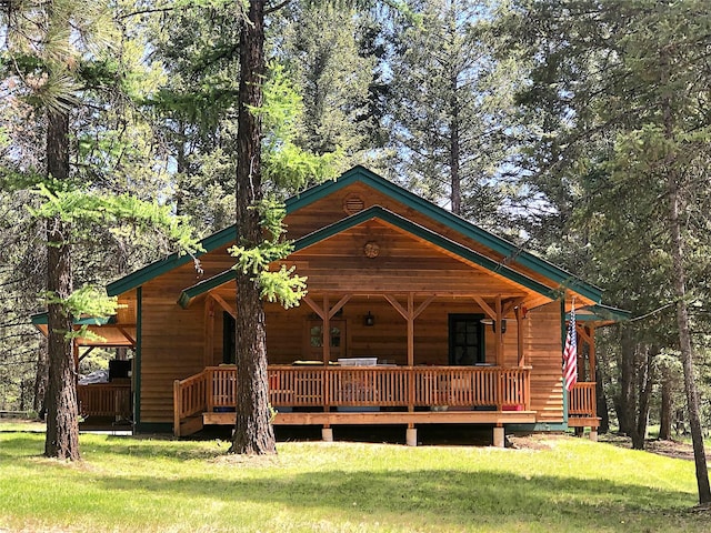 192 Crystal Lakes Dr, Eureka, MT 59917 - view of front of home featuring a front lawn and a deck