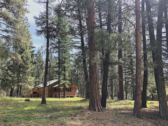 192 Crystal Lakes Dr, Eureka, MT 59917 - view of yard featuring a forest view and a deck