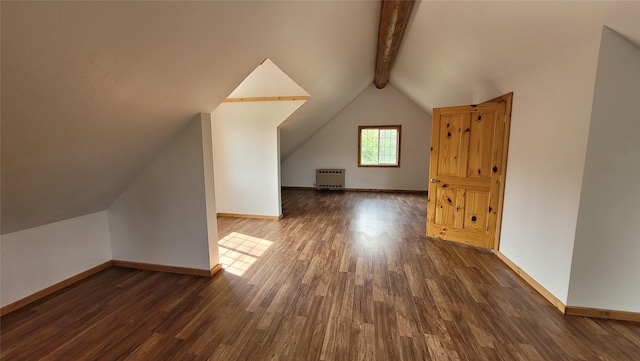 additional living space with dark wood-type flooring, radiator heating unit, and lofted ceiling with beams