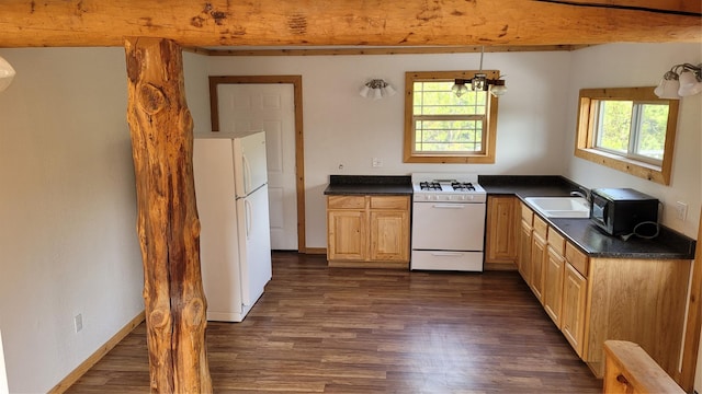 kitchen featuring dark hardwood / wood-style flooring, sink, white appliances, and plenty of natural light