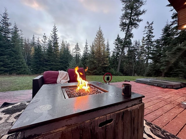 view of patio / terrace with a deck and a fire pit