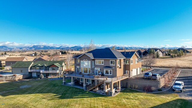 4428 Fox View Loop, Helena, MT 59602 - rear view of house with a residential view, stucco siding, a garage, and a yard